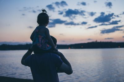 silhouette of man holding a child